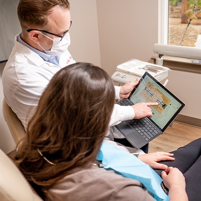Dr. Shively walking a patient through their X-rays on a tablet